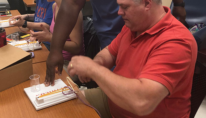 A man performing stitching at Wisconsin Wound Closure Workshop